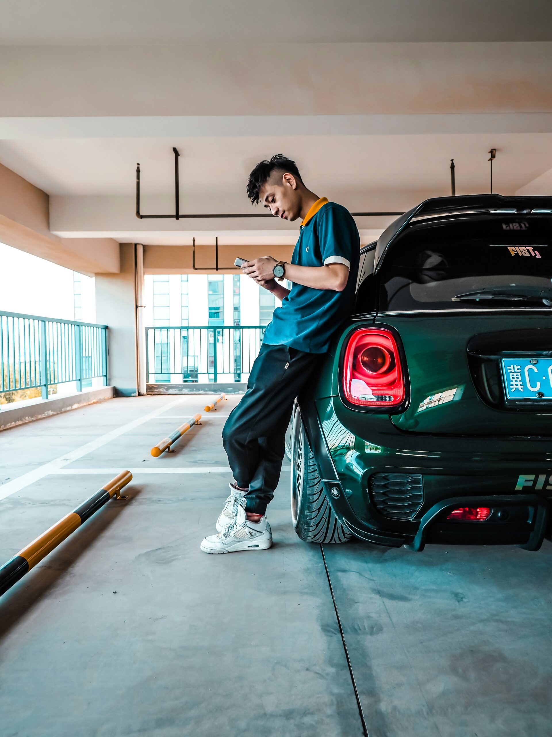 man leaning on green vehicle